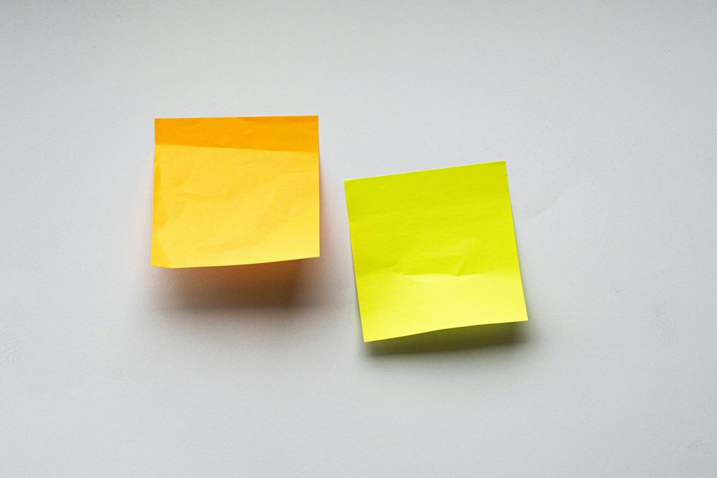 Two blank sticky notes on a white wall, representing WordPress Notes for team feedback